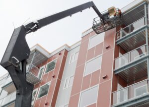 Boom lift worker work apartment highrise exterior